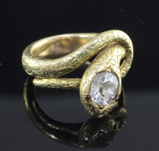 An early 20th century Indian gold and solitaire diamond serpent ring, size M.
